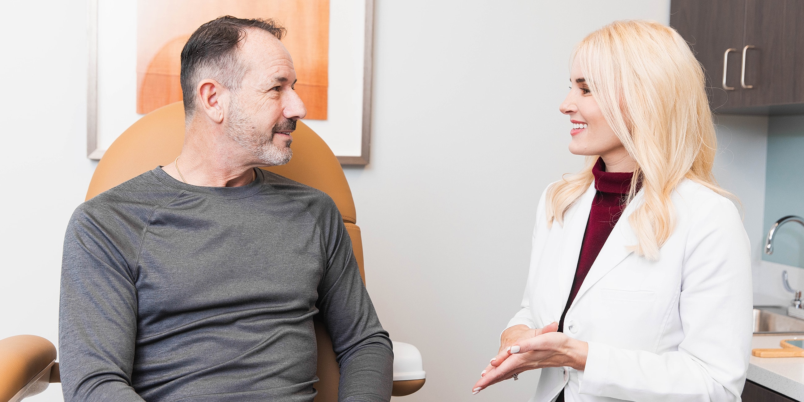 Atlanta gynecomastia surgery model-patient consultation with medical professional in clinic.
